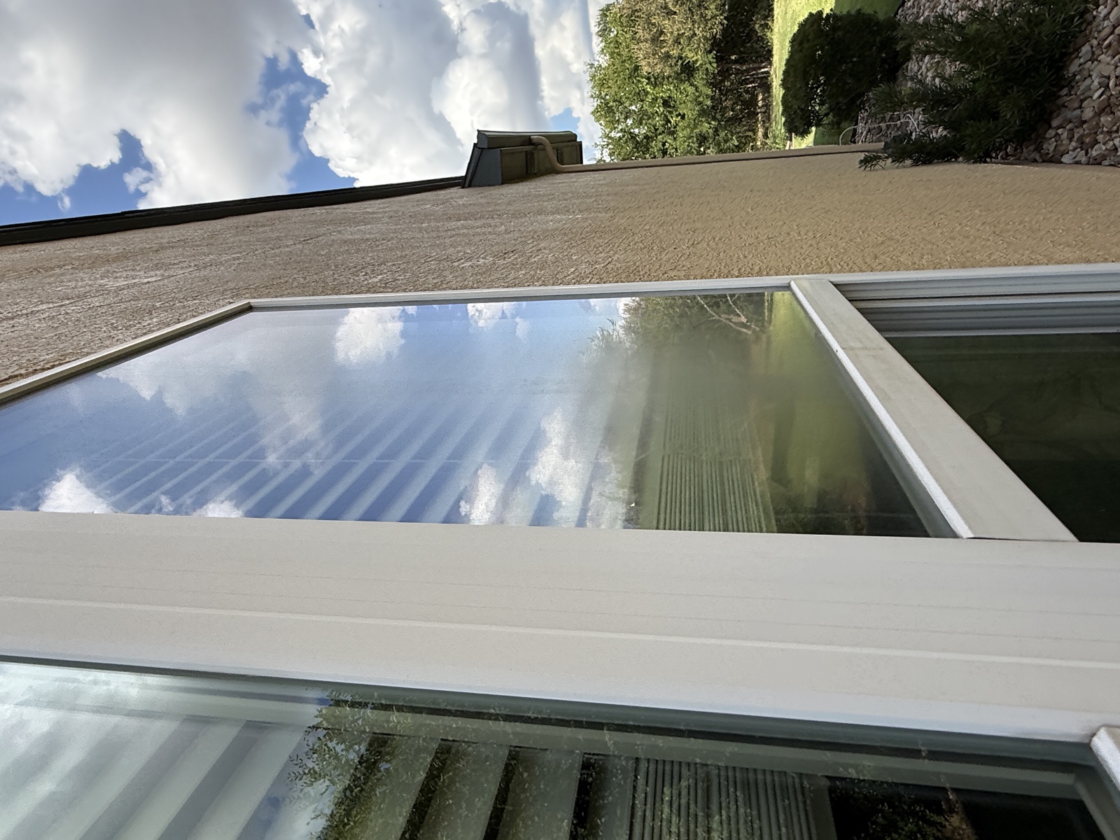 Residential side window with haze and buildup before cleaning